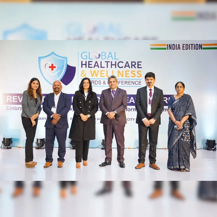 Vedaya receiving the International Business Awards 2025 trophy on stage